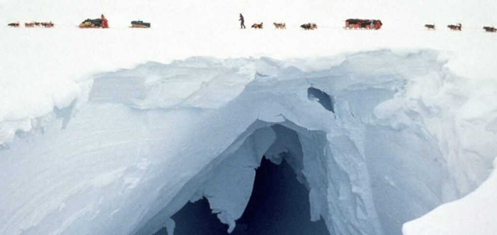 Transantarctica team members Keizo Funatsu (Japan), Jean-Louis Etienne (France) and Victor Boyarsky (USSR) seem to be immune to wind, ice and cold as they take a break behind their sledge. The 6048 kilometres, 220-day expedition from the tip of the Antarctic Peninsula via the South Pole to the coast of East Antarctica, Transantarctica still stands as the longest crossing of the southern continent.